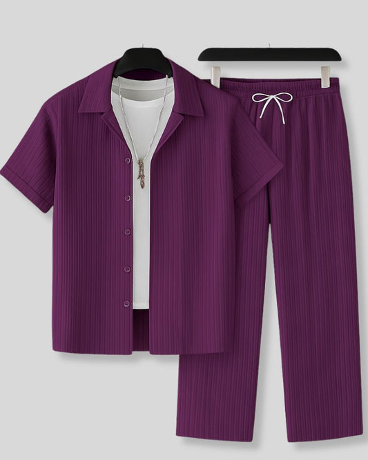 Purple ribbed shirt and pants set on hangers against a white background