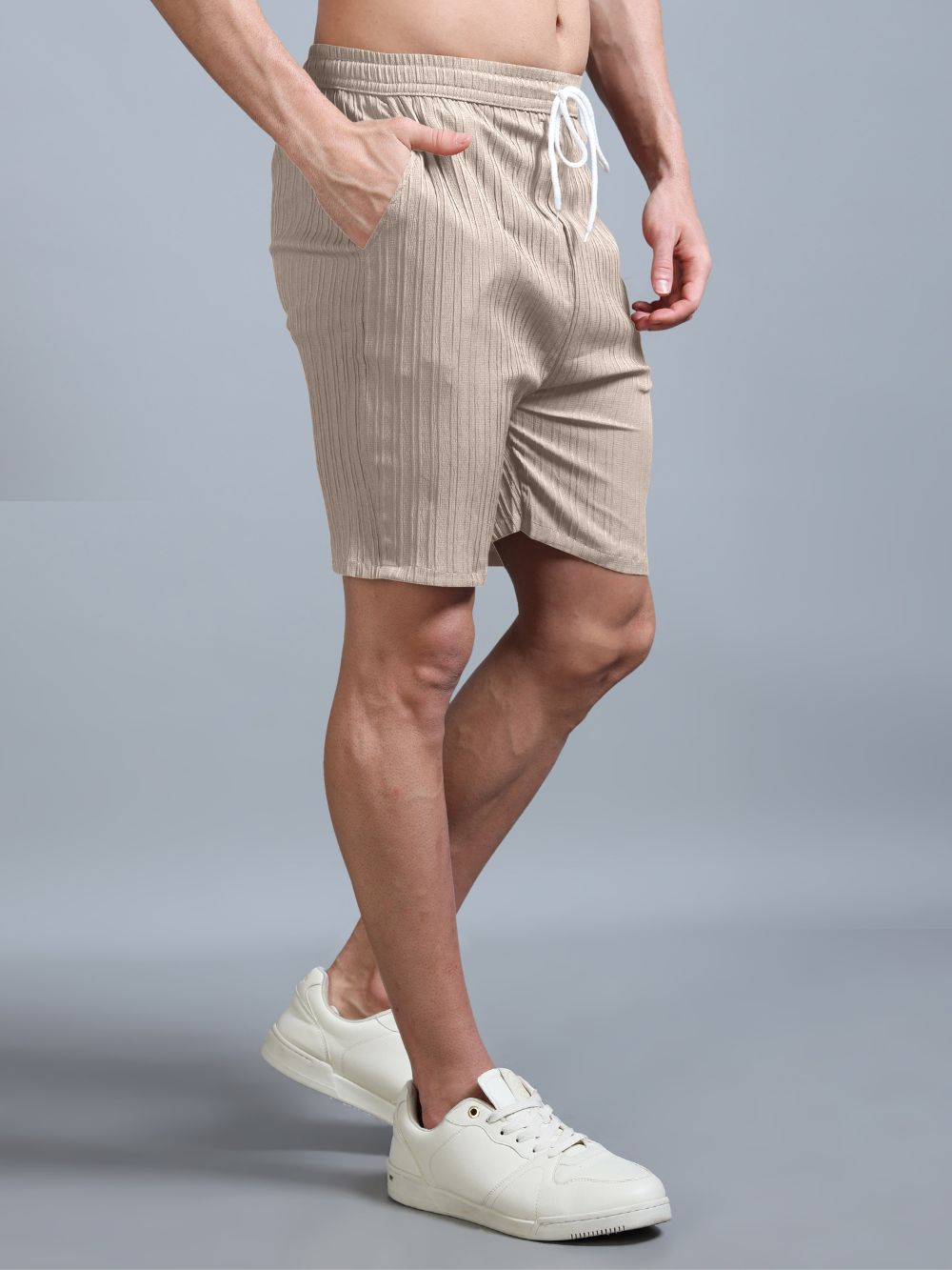 Side view beige co-ord shorts with sneakers
